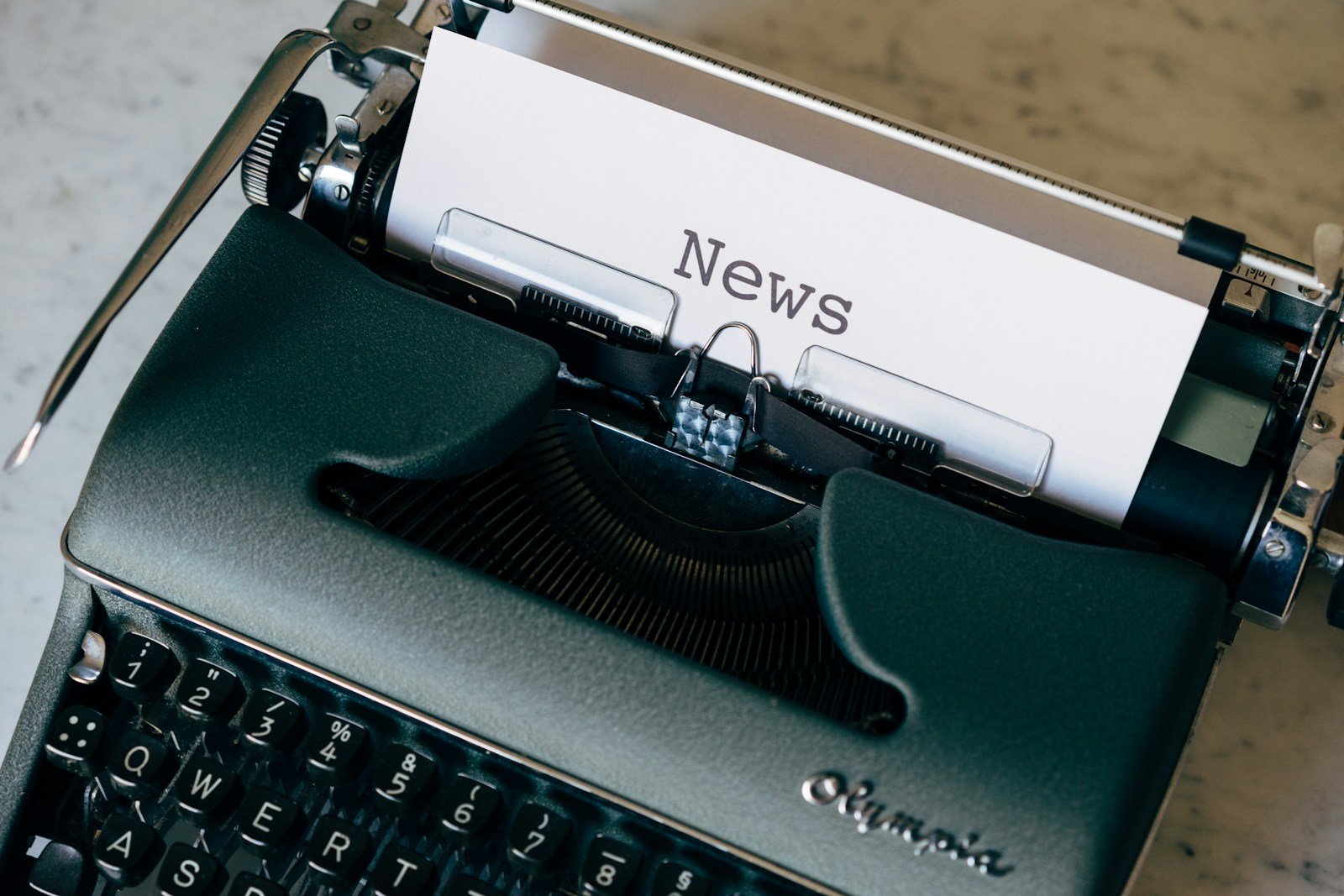 Newsroom desk with printed headlines and editorial markup